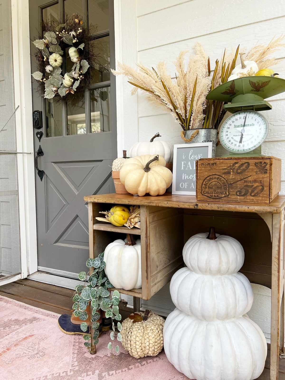a porch with a table and pumpkins