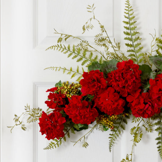 a bunch of red flowers on a white door