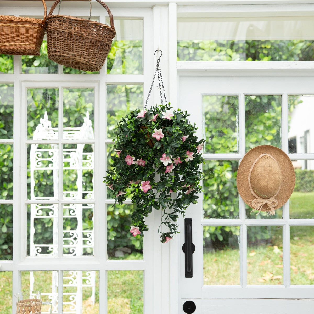 a door with a basket and a plant from it