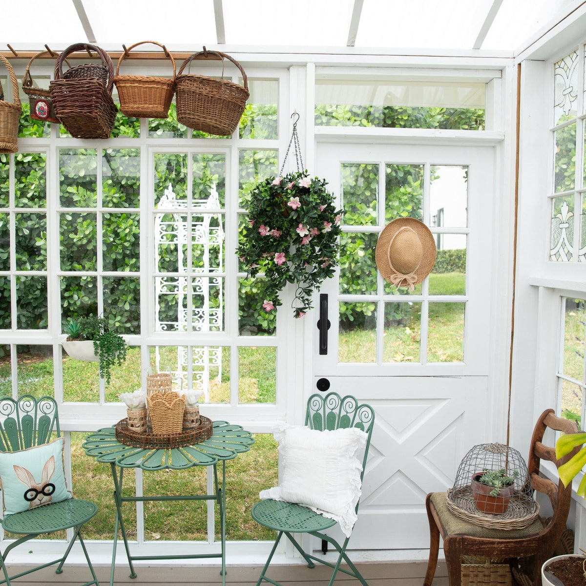 a room with a white door and a white door with a green table and chairs