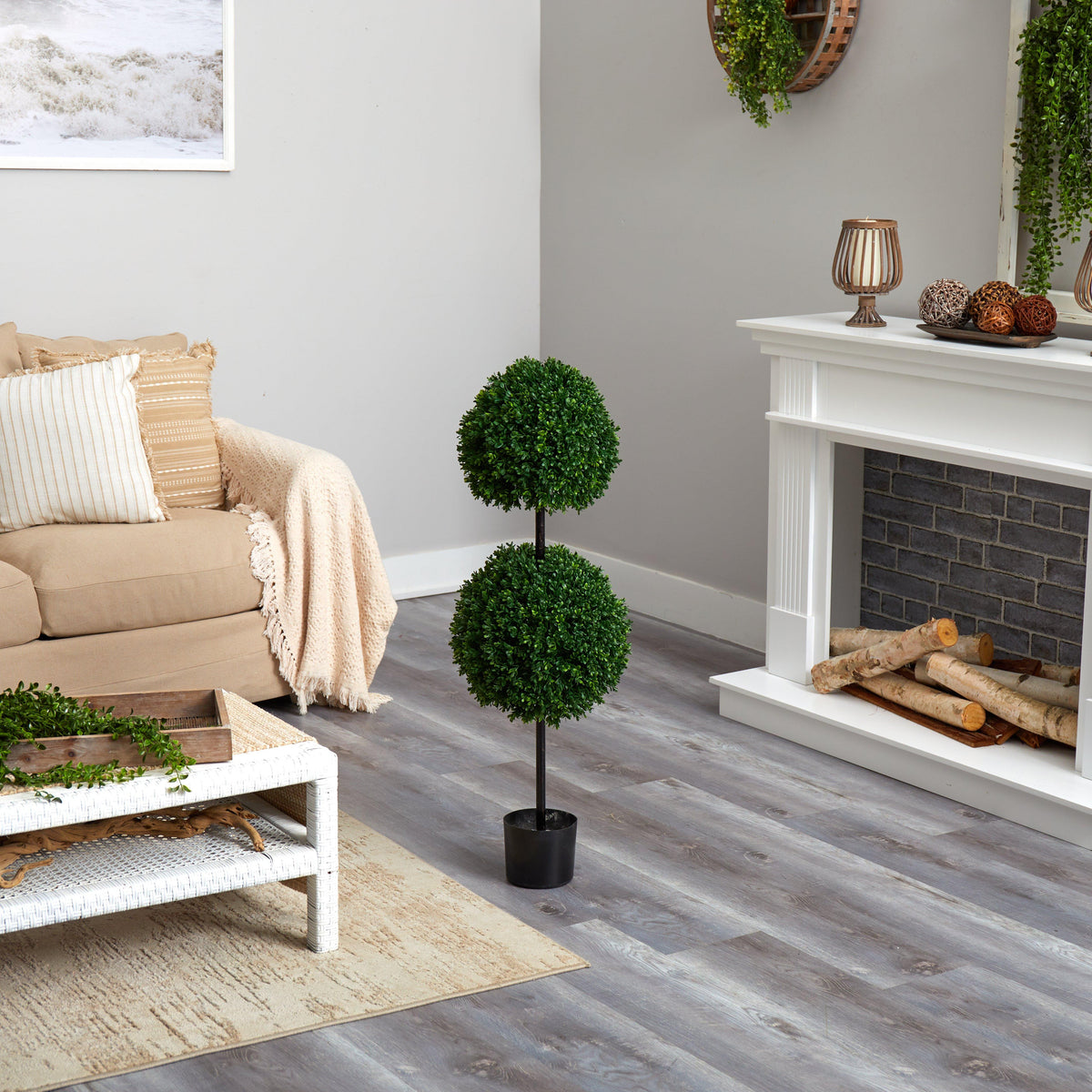 a living room with a fireplace and a tree