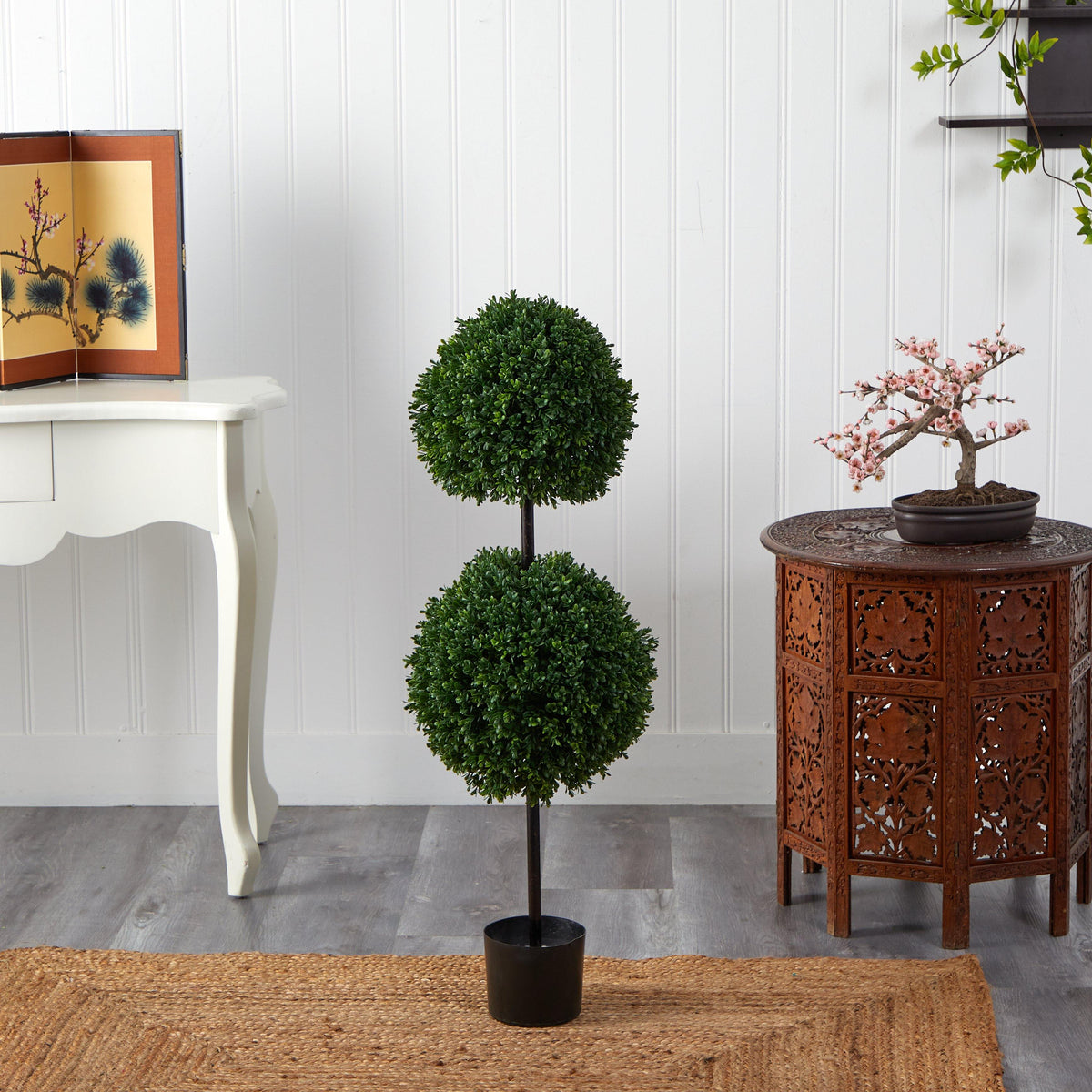 a potted plant on a rug next to a table