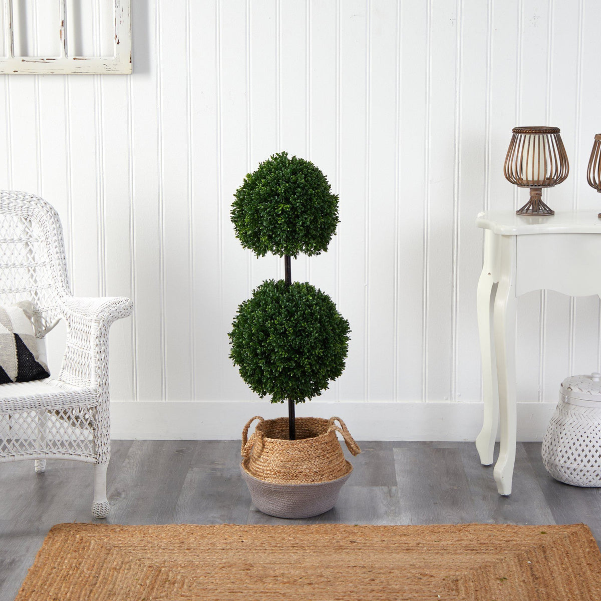 a plant in a basket next to a table and chairs