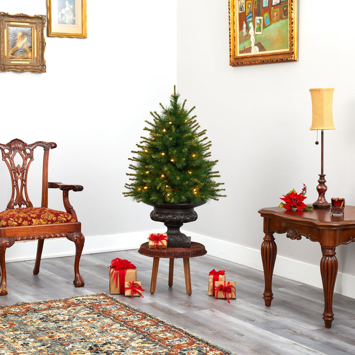 a christmas tree in a room with a table and chairs