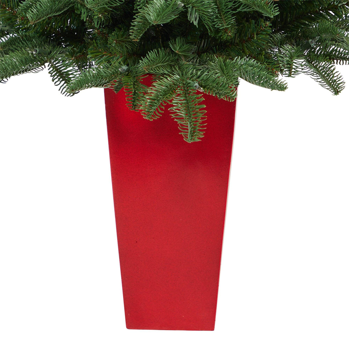 a red planter with green leaves