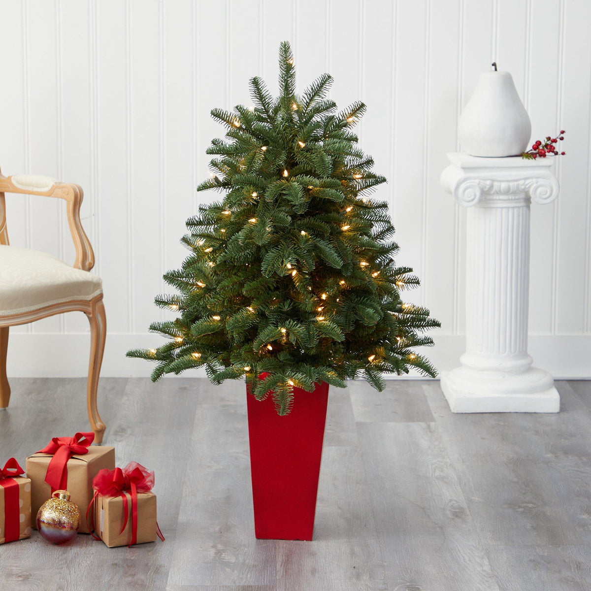 a christmas tree in a red pot with lights