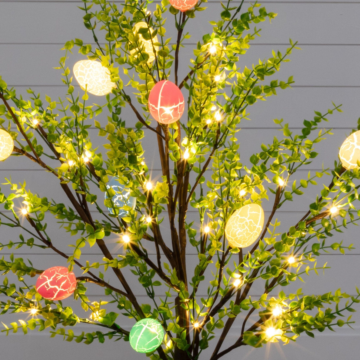 a tree with lights and eggs