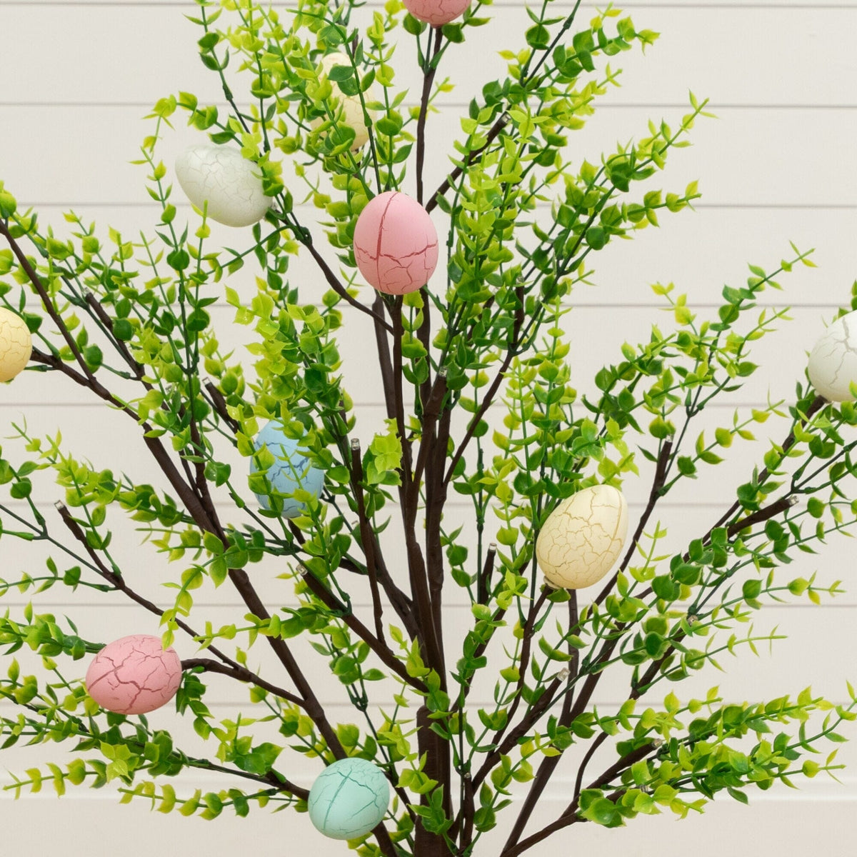 a tree with fake eggs and leaves