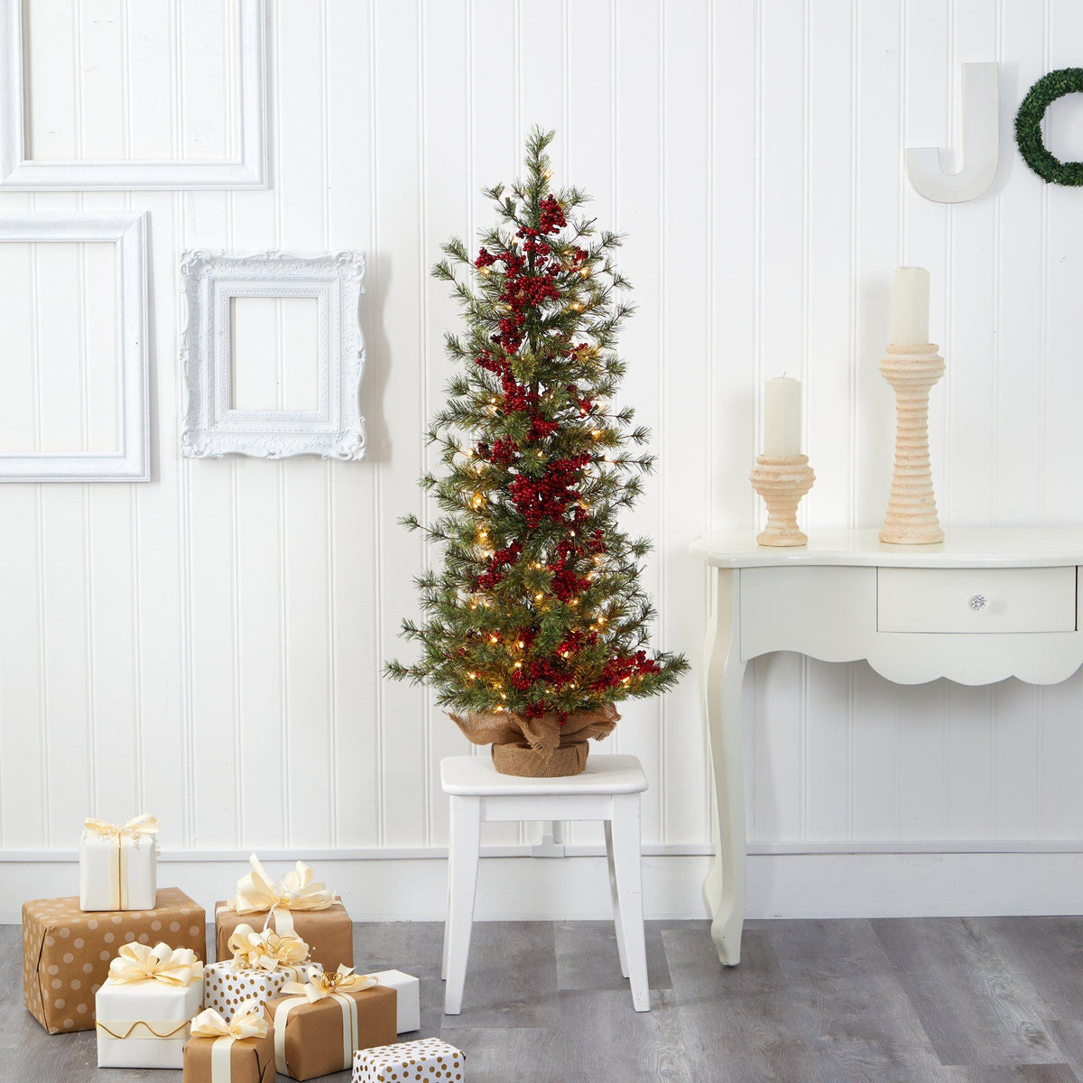 a small christmas tree with lights and presents