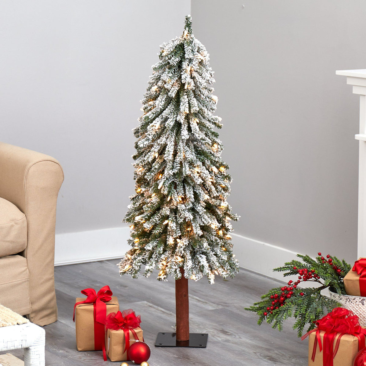 a christmas tree with presents in the corner of a room
