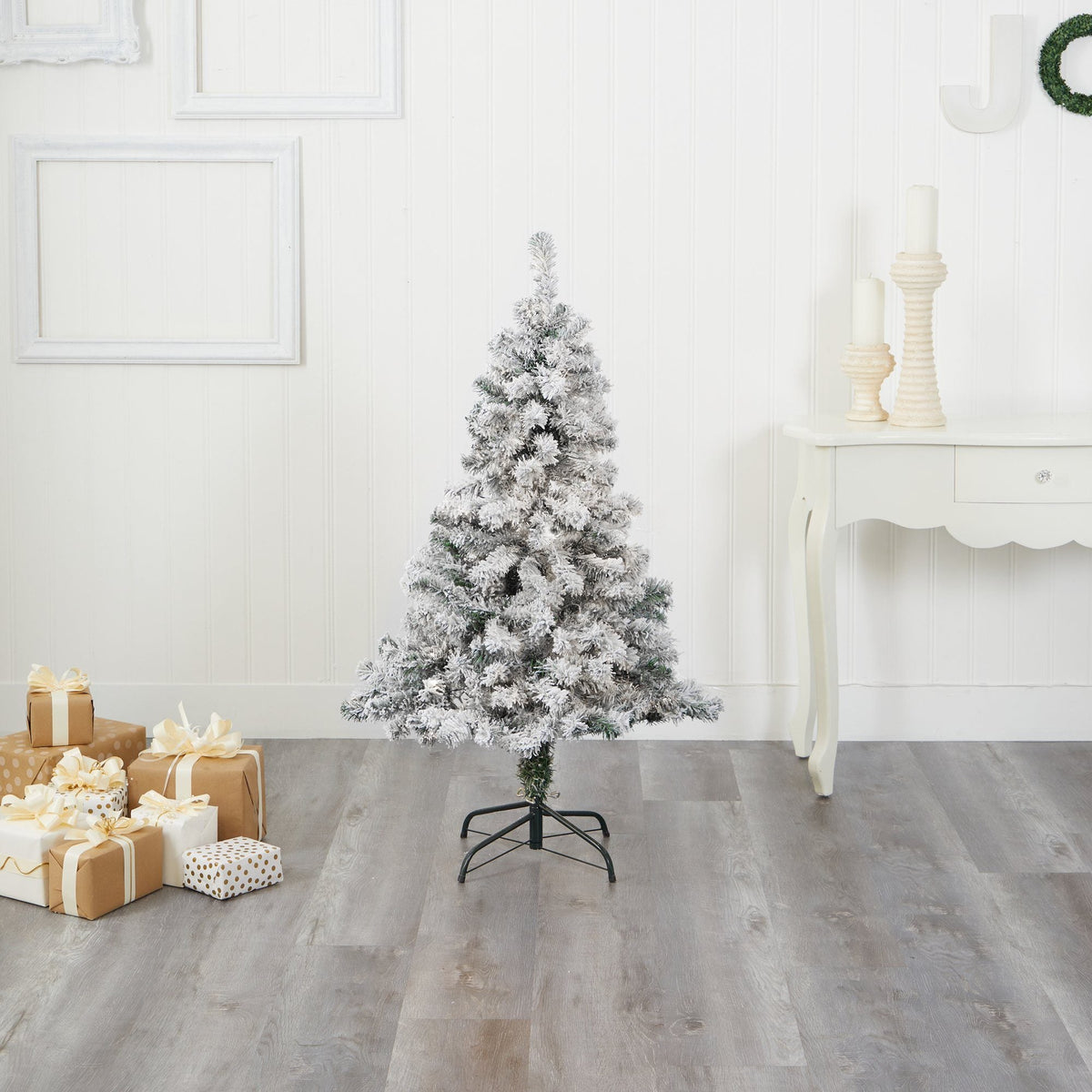 a christmas tree with presents in front of it