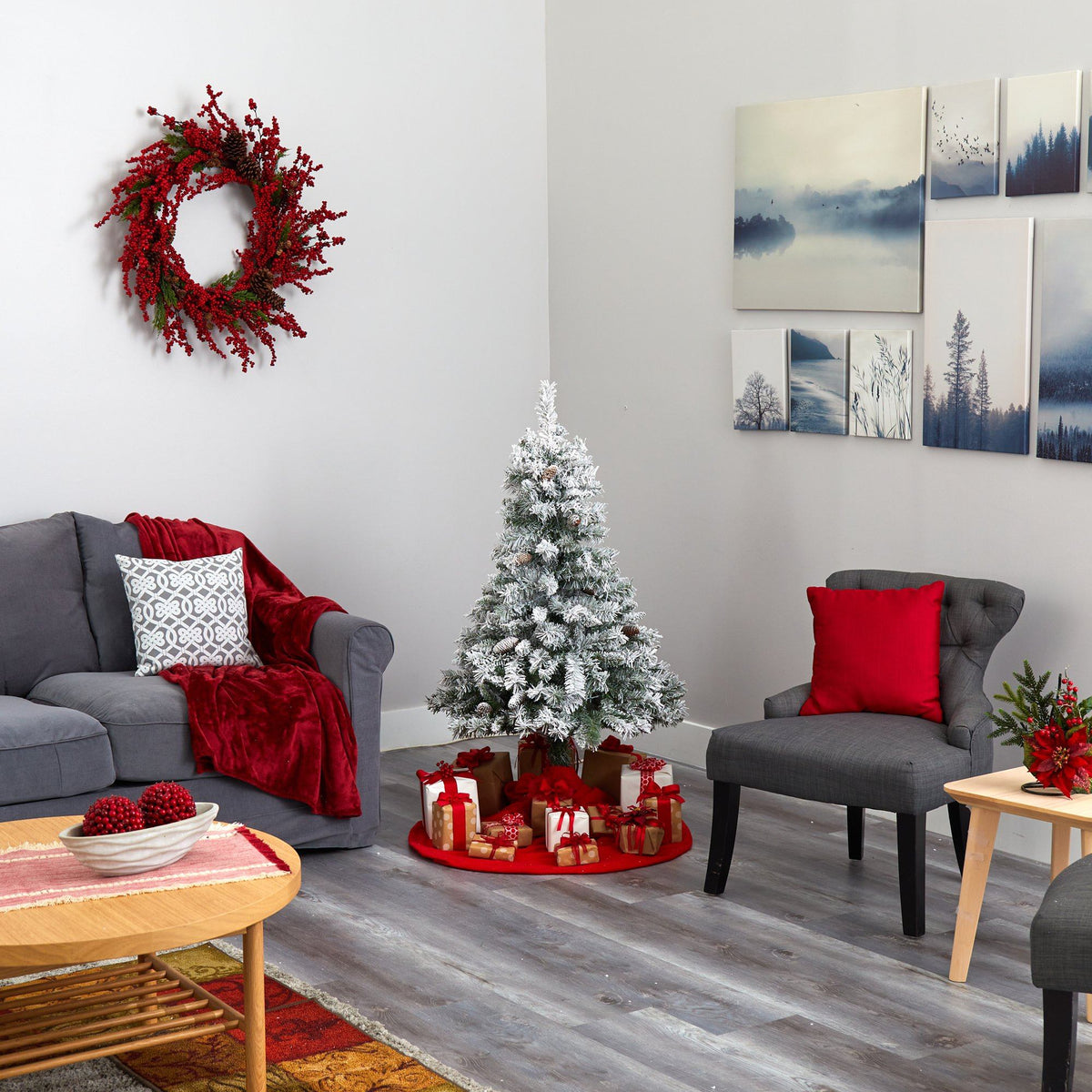 a living room with a christmas tree and a wreath on the wall