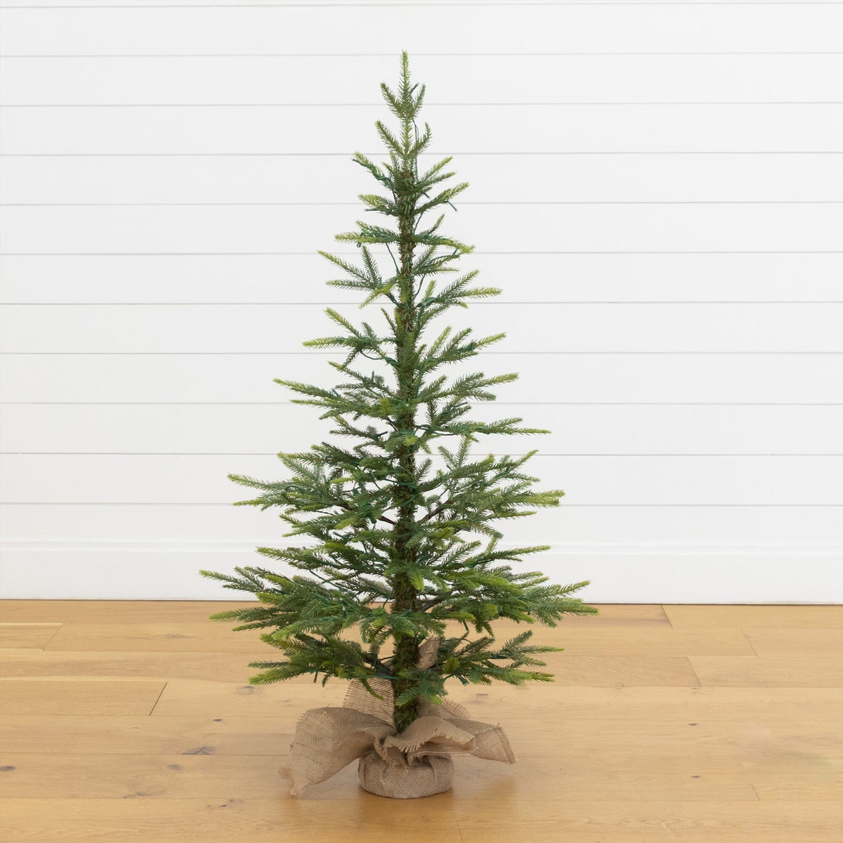 a small christmas tree on a wood floor