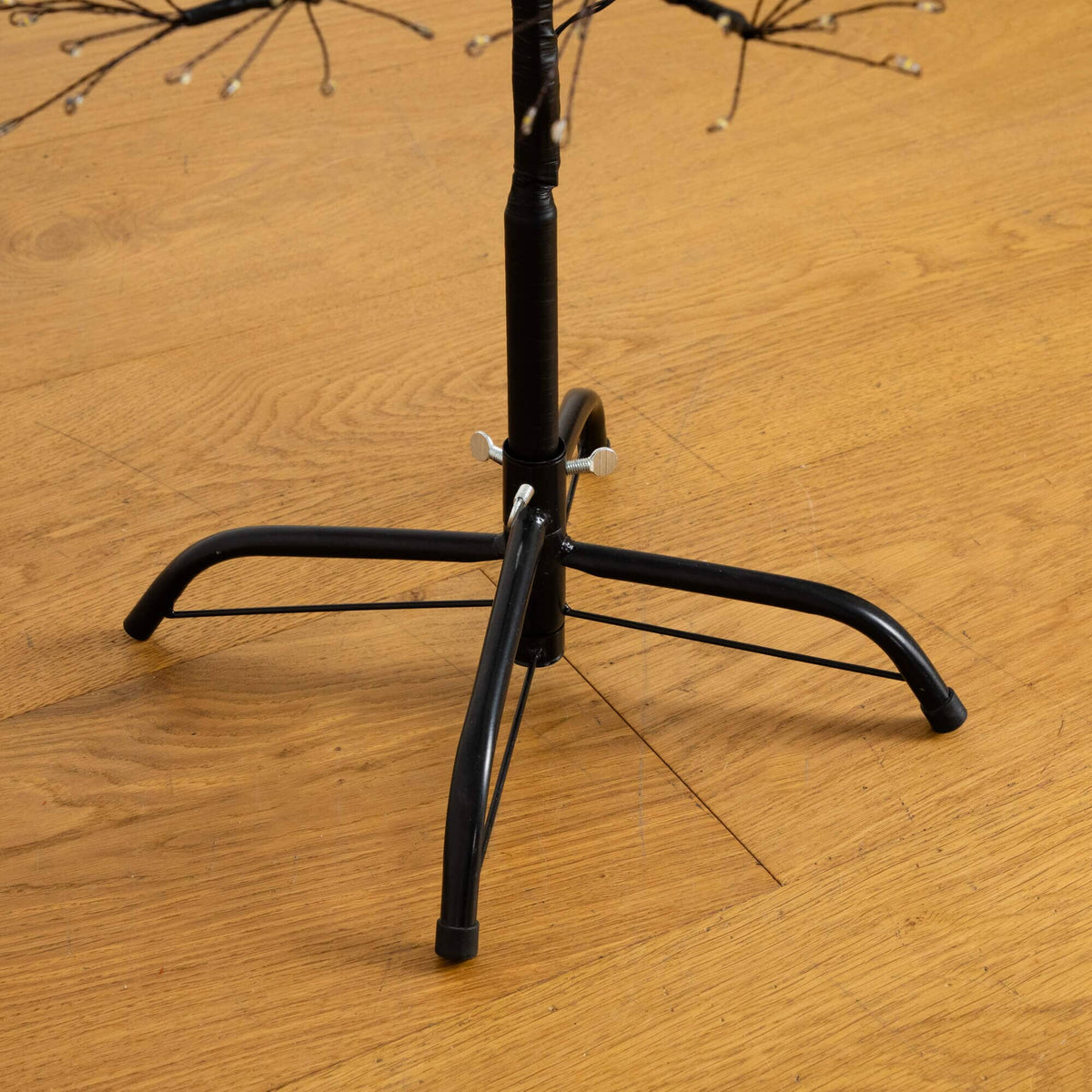 a black stand on a wood floor