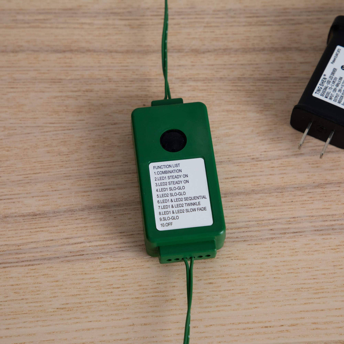 a green and black device with a white label