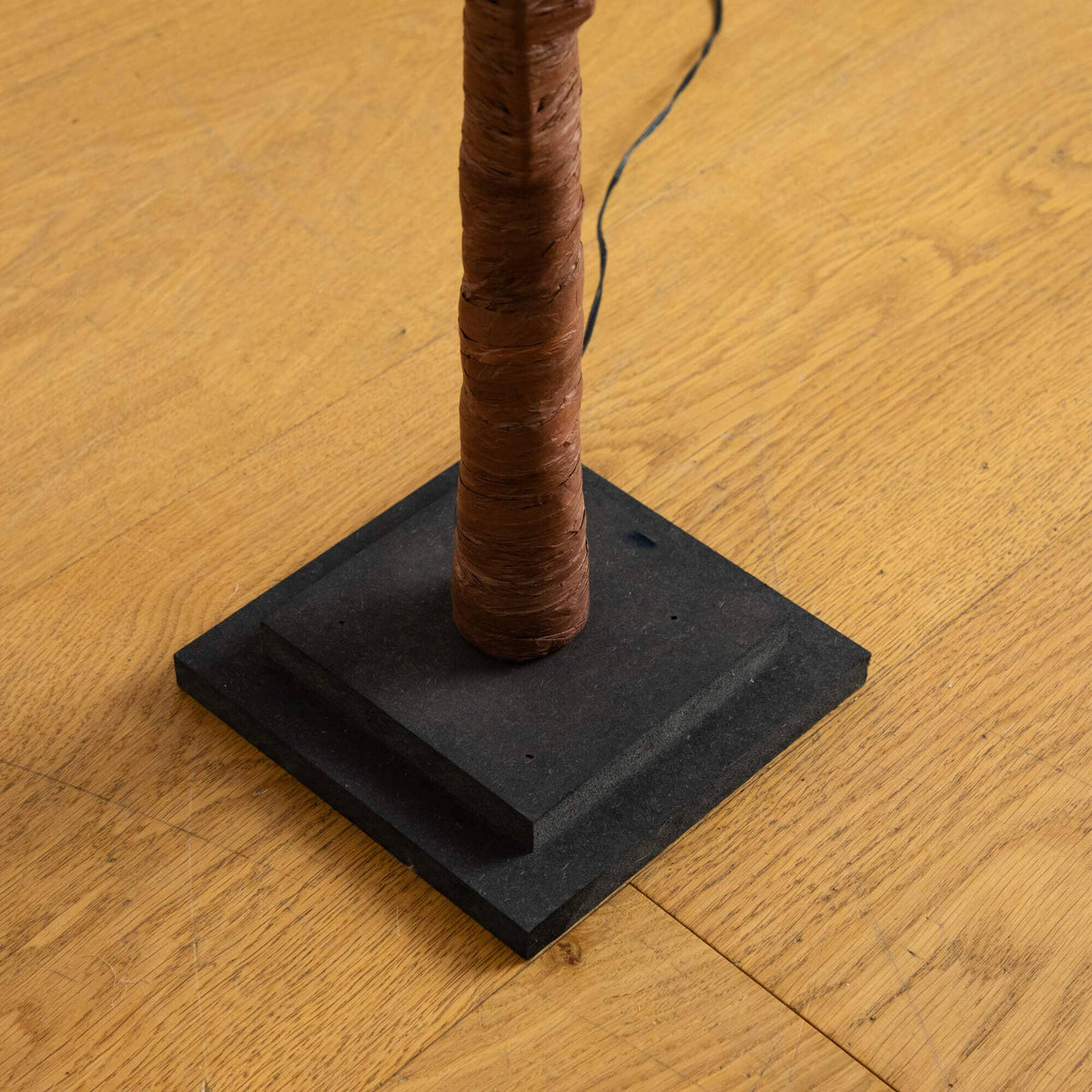 a black base with a brown pole on it