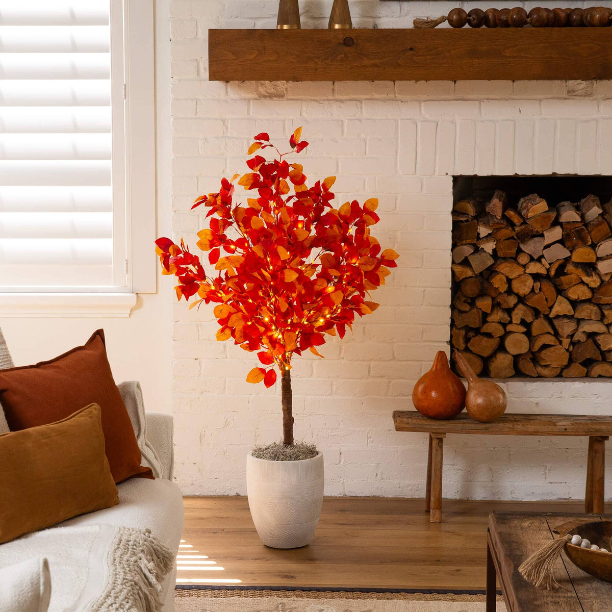 a tree in a room with a fireplace