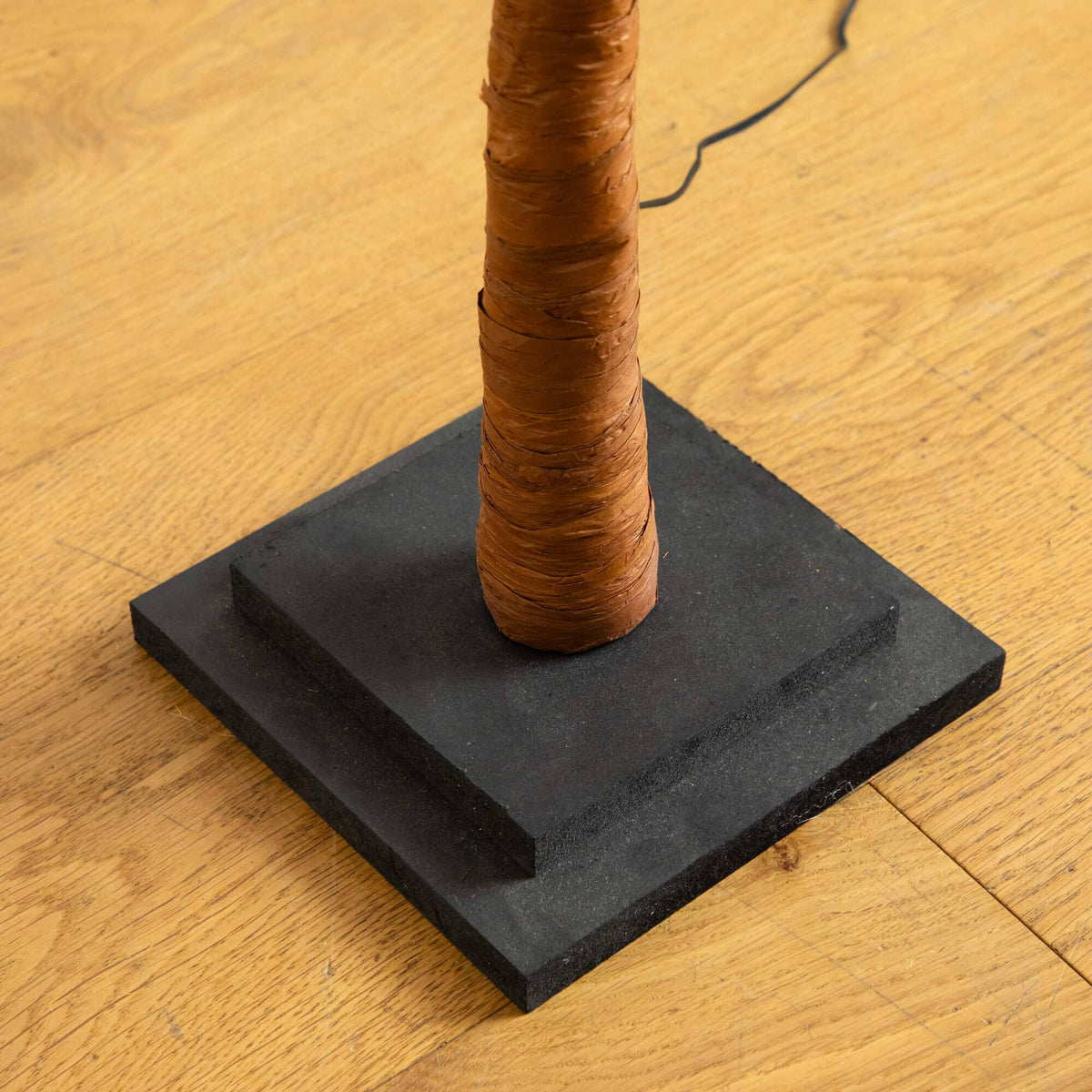 a black square with a brown tube wrapped around it