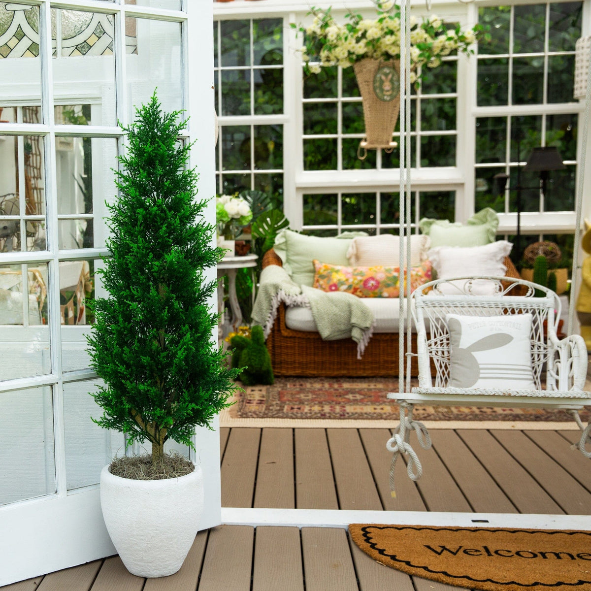 a porch with a tree and a door