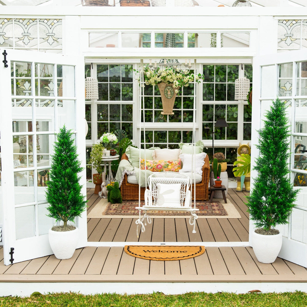 a patio with a white chair and trees