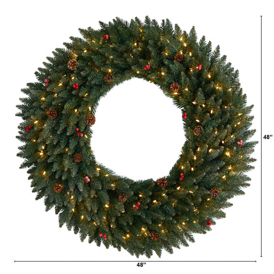 a wreath with lights and pine cones
