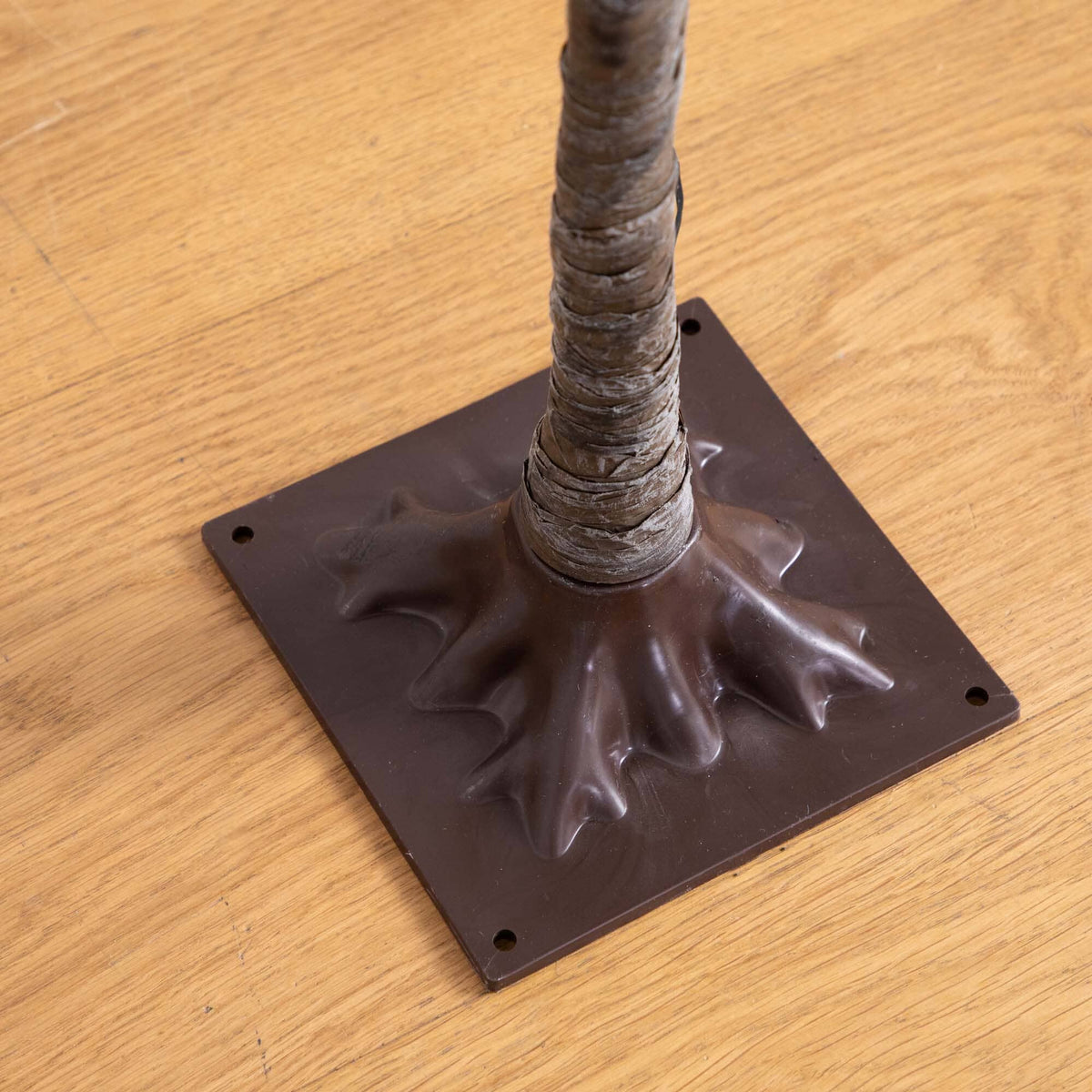 a brown plastic base with a brown stem