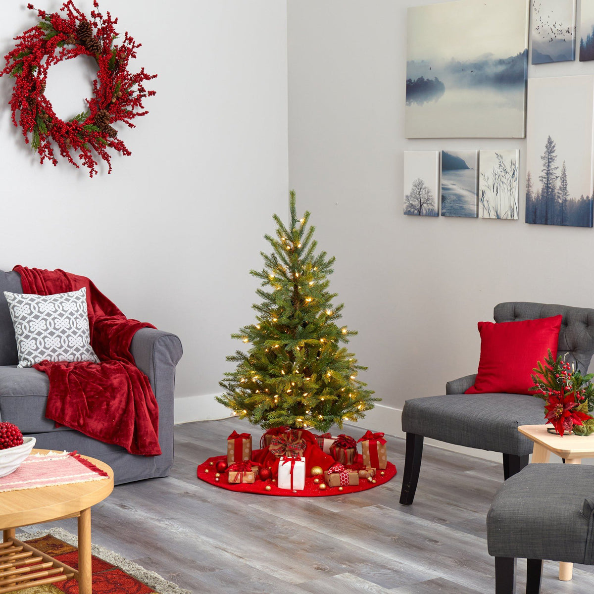 a living room with a christmas tree and chairs