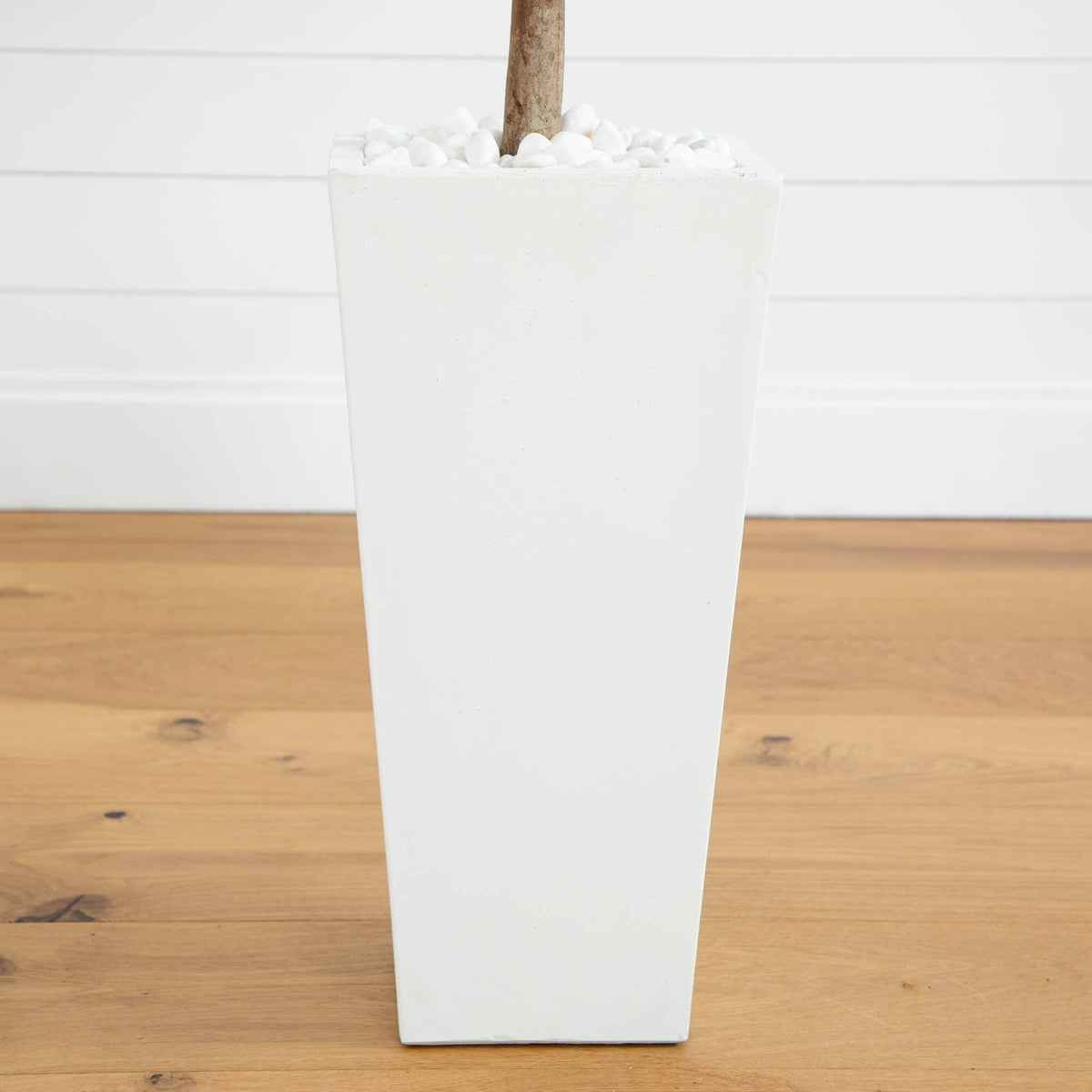 a white rectangular planter with a stick in it