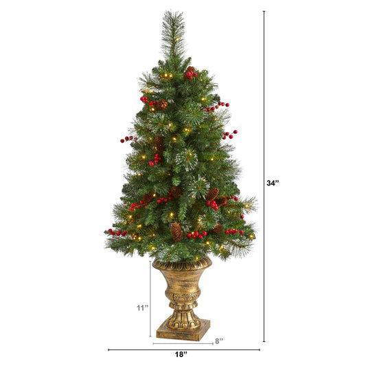 a tall christmas tree with lights and berries