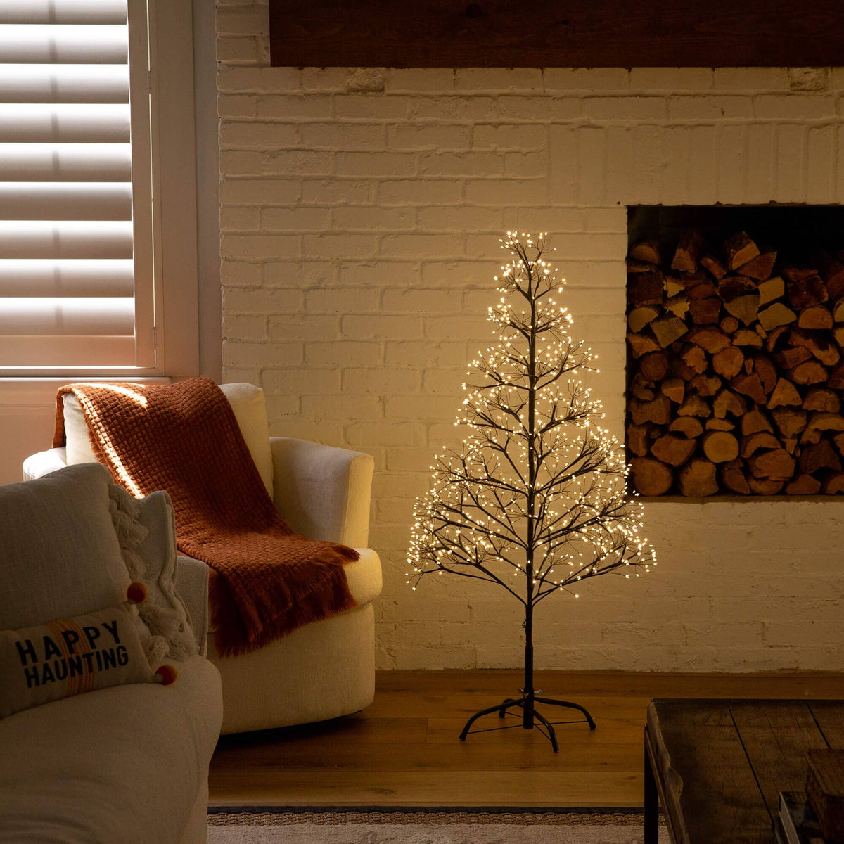 a small tree with lights in a room