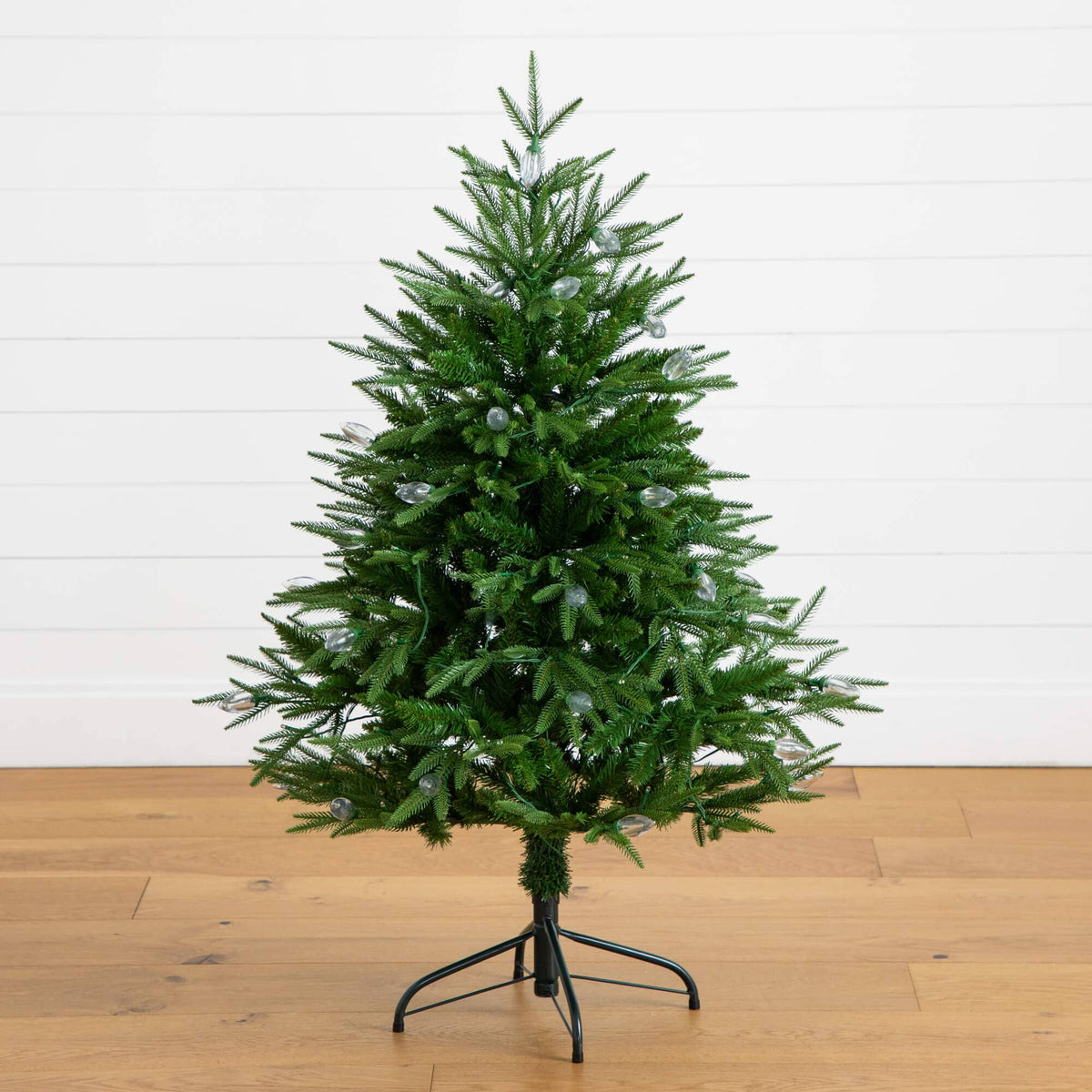 a small artificial christmas tree on a stand
