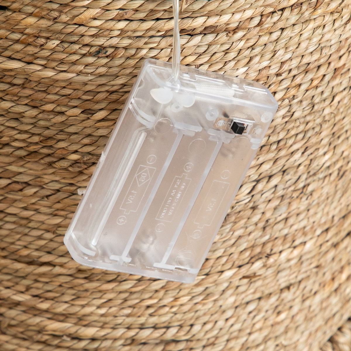 a plastic object with a string attached to it