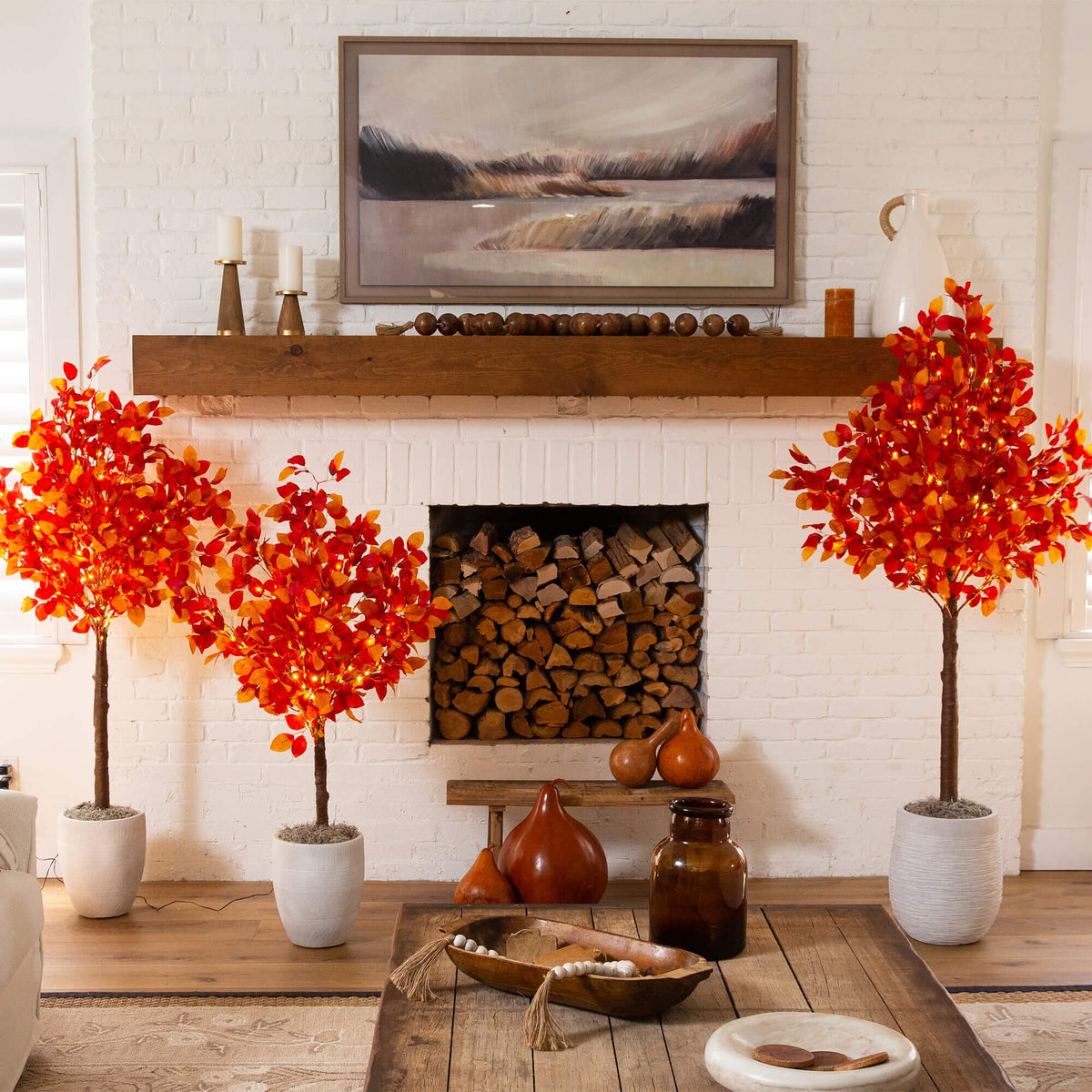 a room with a fireplace and two trees