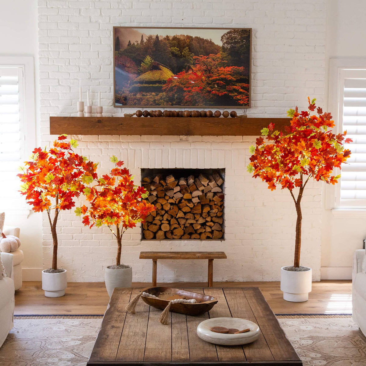 a living room with a fireplace and trees