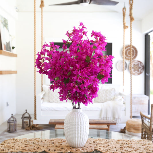 a vase with purple flowers in it