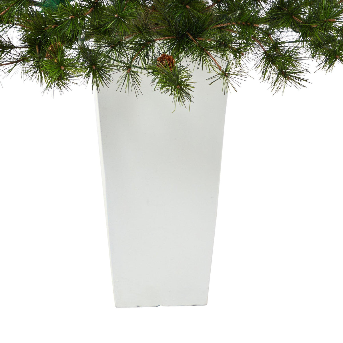 a white rectangular planter with pine branches