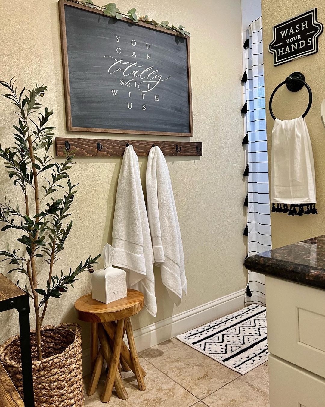 a bathroom with a chalkboard and towels