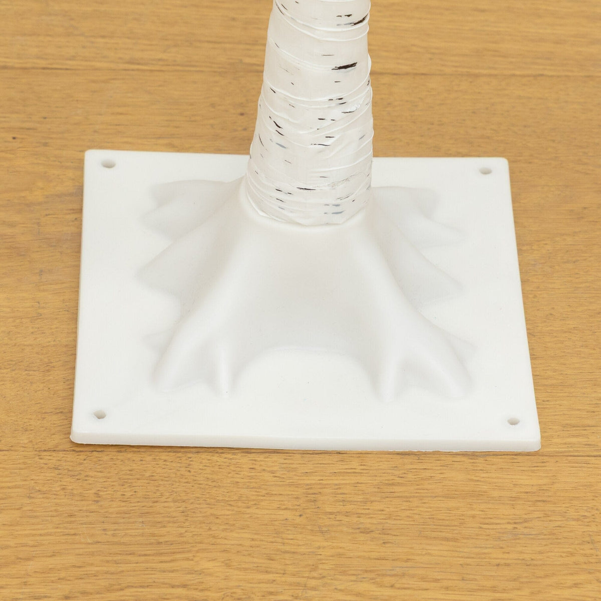 a white plastic object on a wood surface