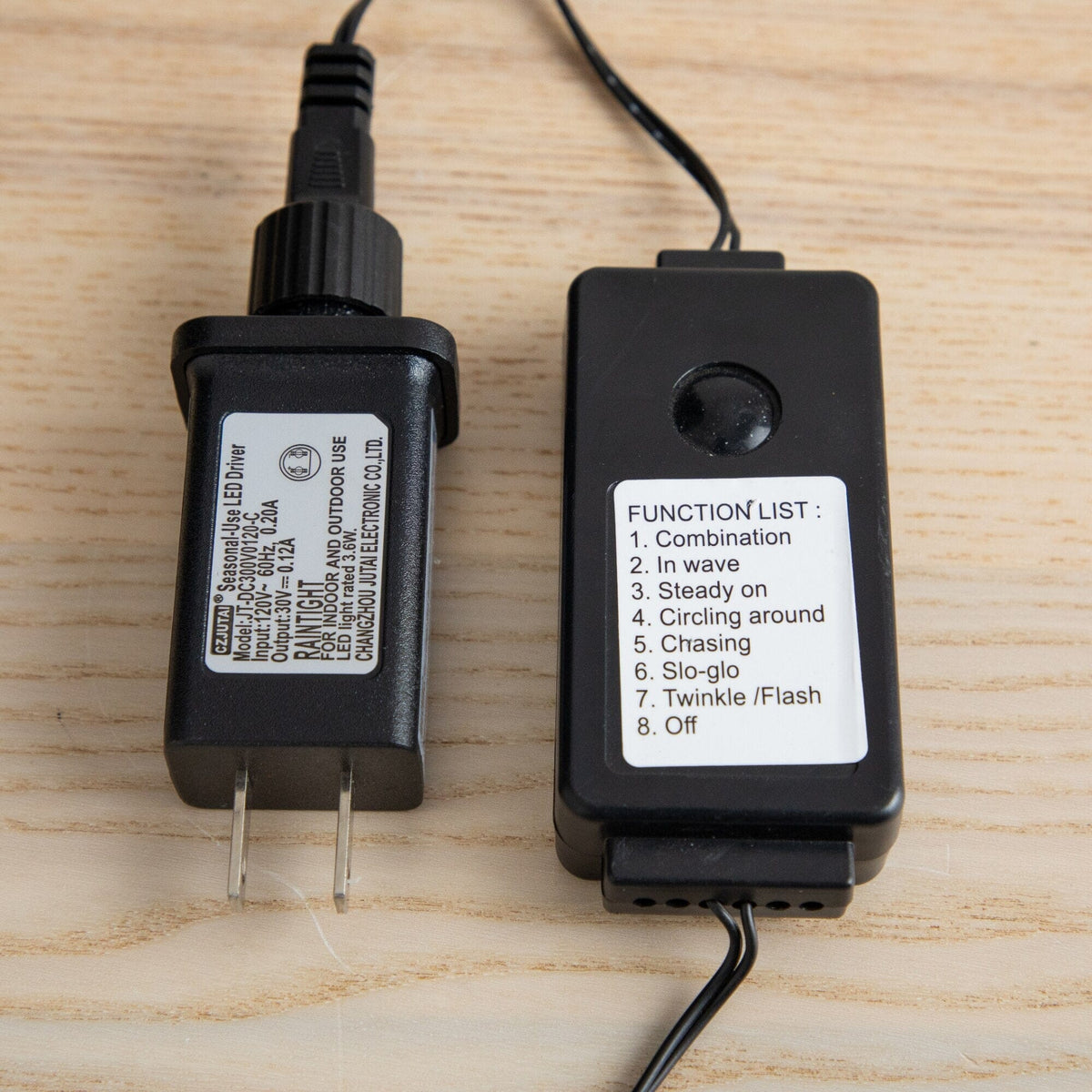 a black battery charger and a black cord
