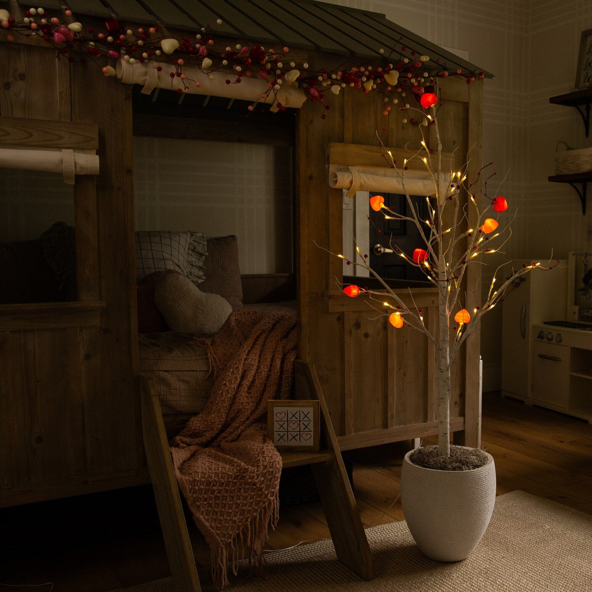 a tree in a pot in a room