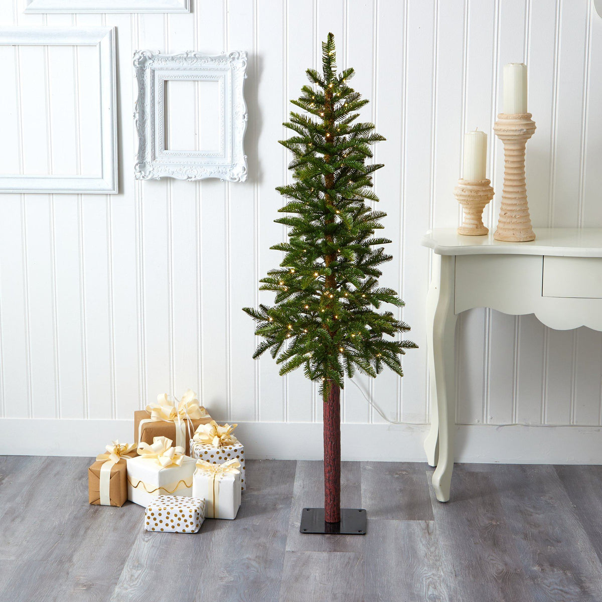 a christmas tree with presents and candles