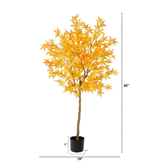 a tree with yellow leaves in a pot
