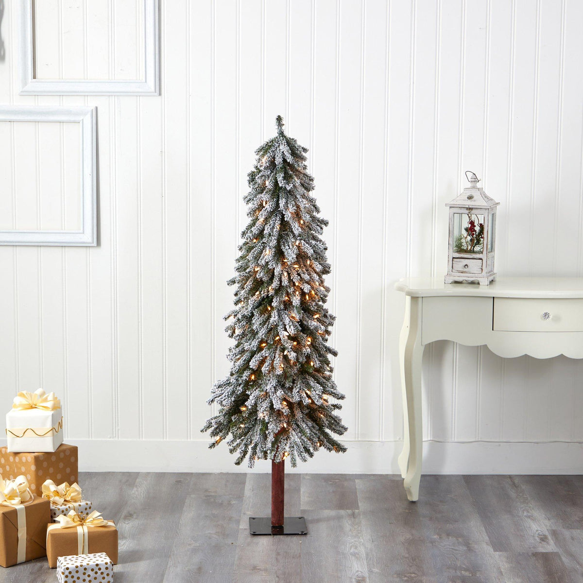 a christmas tree with presents in front of a white table