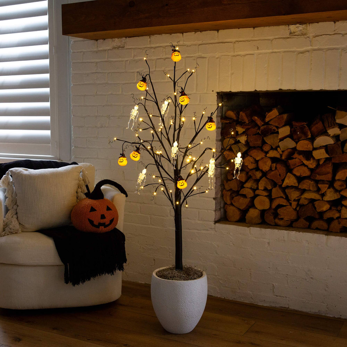 a tree with lights in a room with a fireplace