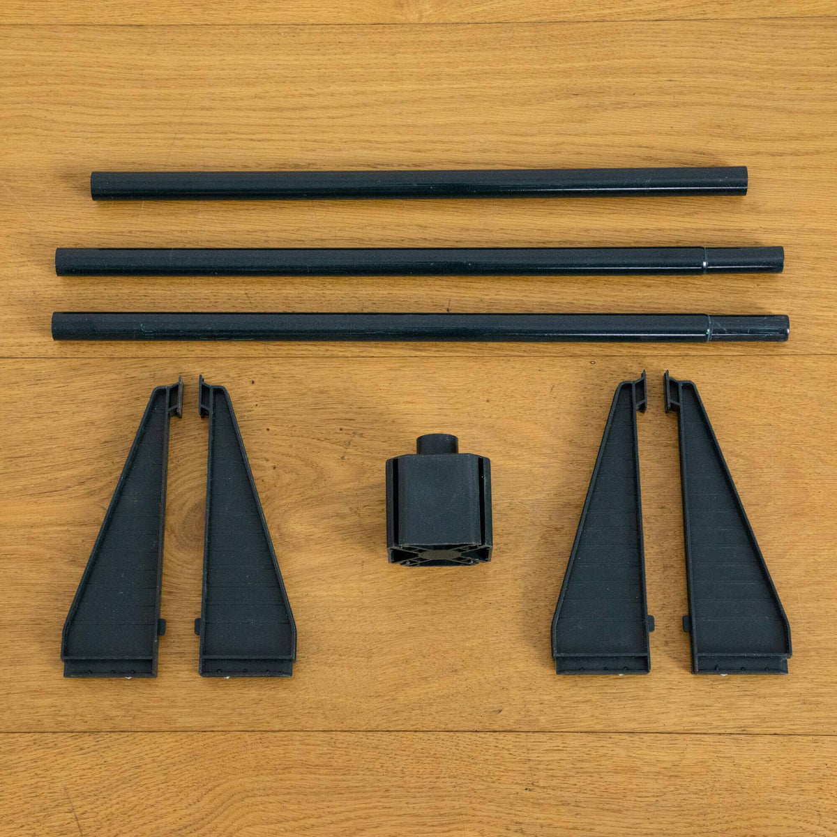 a black plastic parts on a wood surface