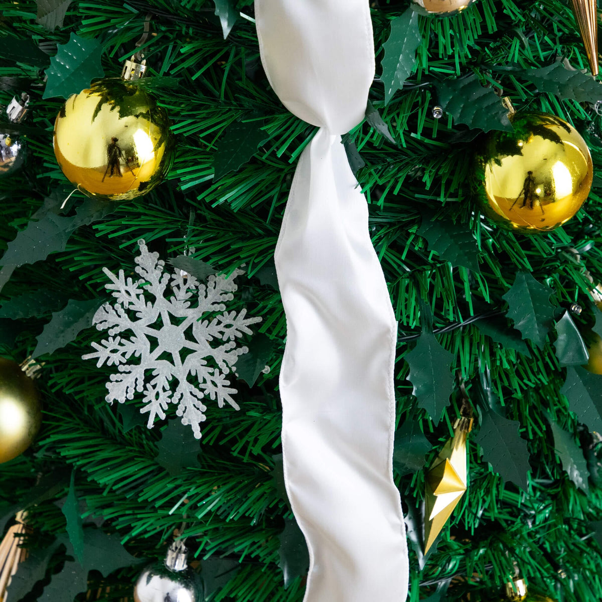 a white ribbon on a christmas tree