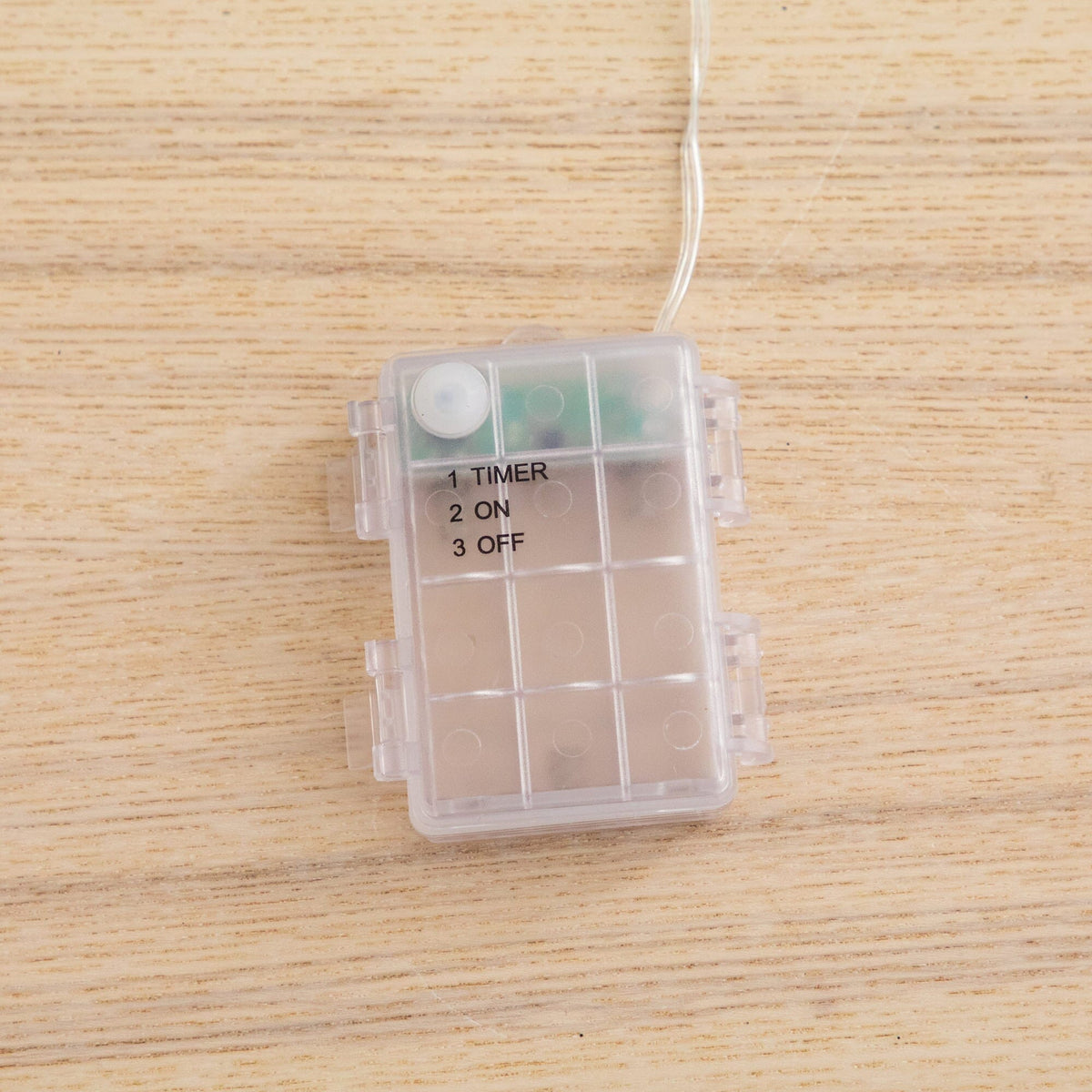 a plastic box with a string