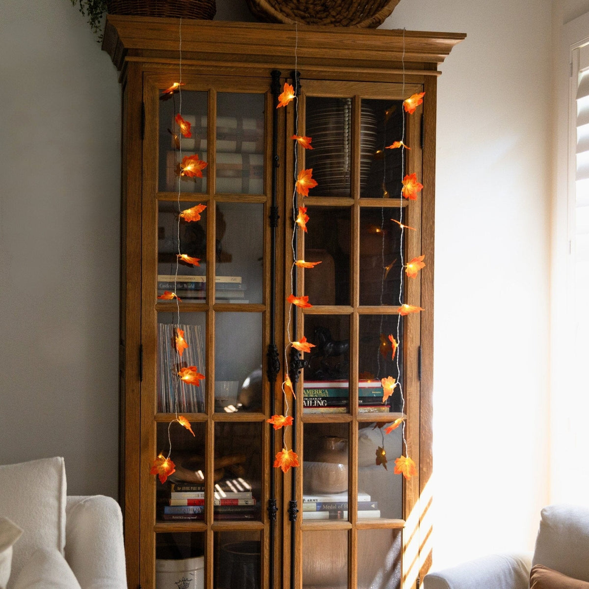 a wooden cabinet with a string of leaves from it