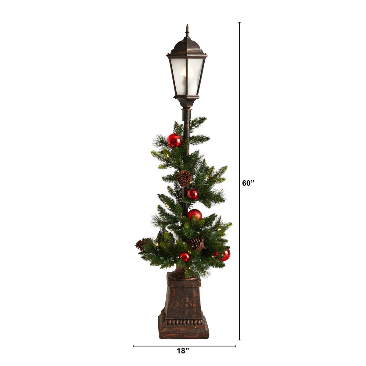 a tall lamp post with a small pine tree and red balls