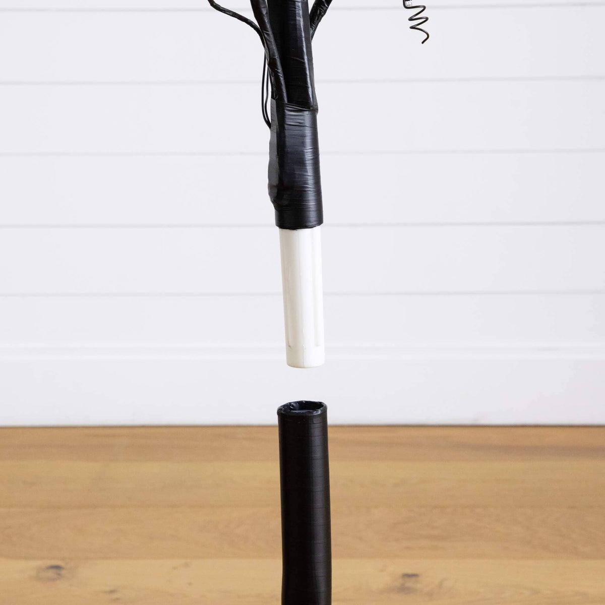 a black and white object with a black cord